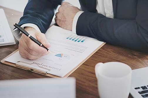 Man looking at a financial plan on a clipboard