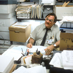 Milton from office space at his very messy desk
