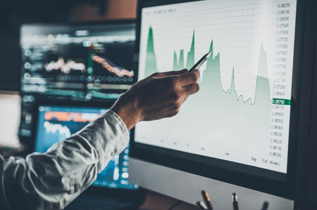 hand pointing to graph on computer