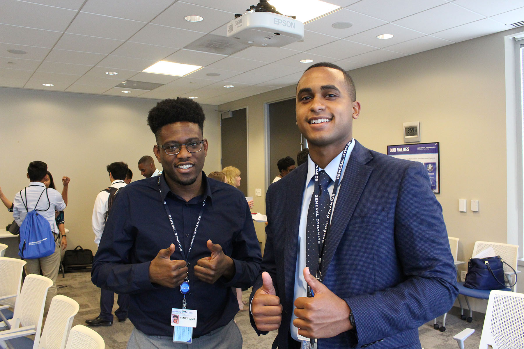 group of employees smiling and giving thumbs up